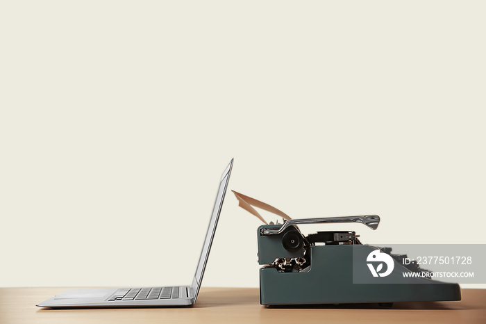 Old typewriter and laptop on table. Concept of technology progress