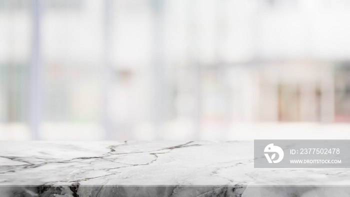 Empty white stone marble table top and blurred abstract interior from restaurant and coffee shop bac