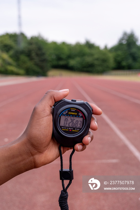 Close-up�of hand holding stopwatch at running track