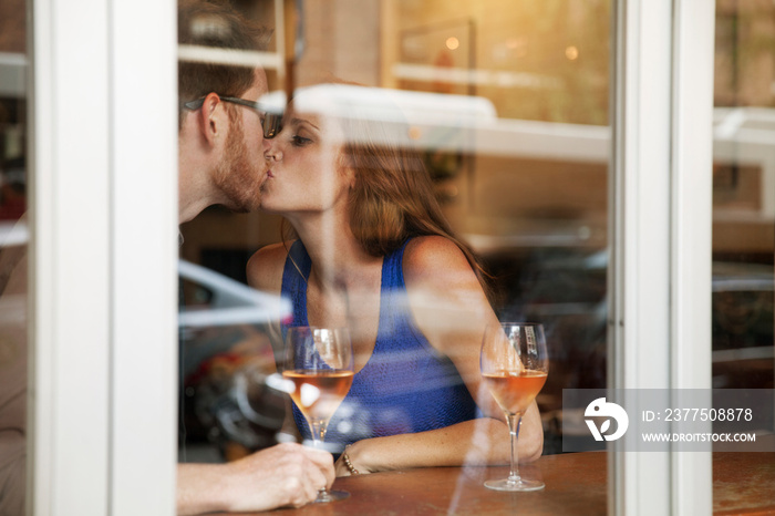 Couple kissing in restaurant