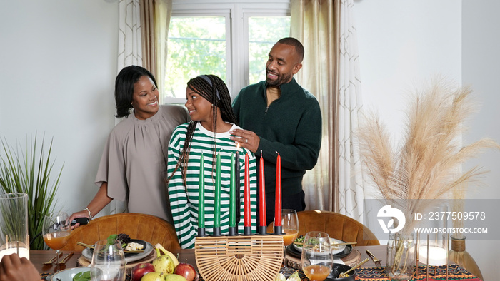 Family with daughter (12-13) having Kwanzaa meal