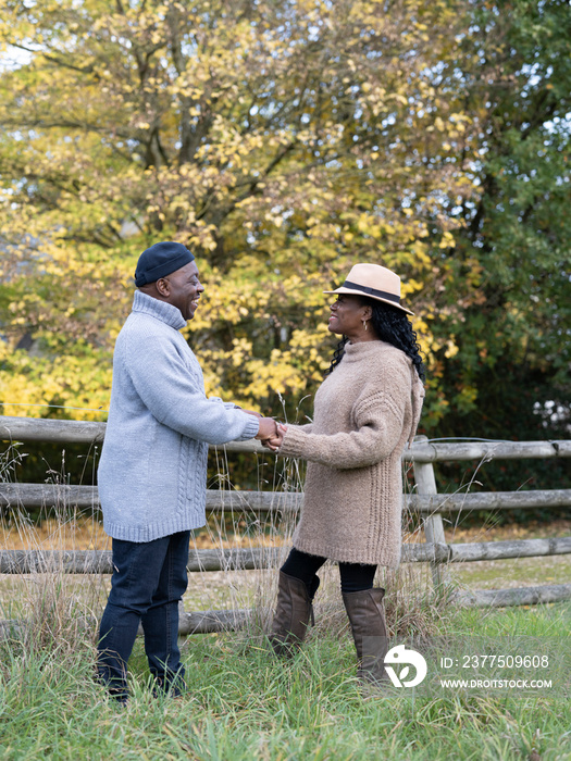 Portrait of couple standing and holding hands in nature