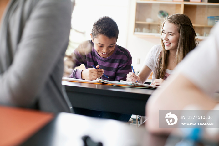 Middle school students taking notes in class