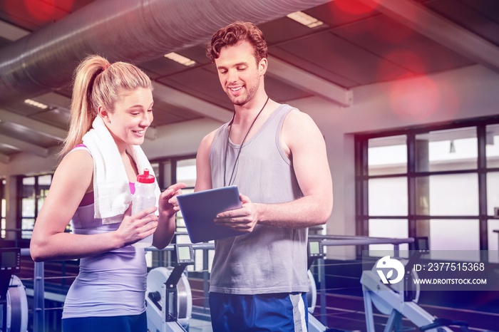 Woman talking to trainer after workout