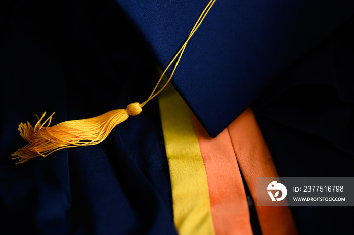 .Close-up Black Graduation Hat and Yellow Tassel placed on the floor