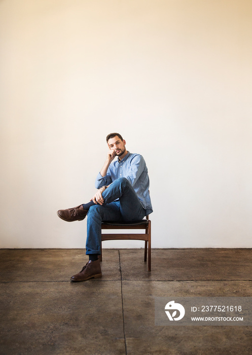 Portrait of young man wearing denim shirt