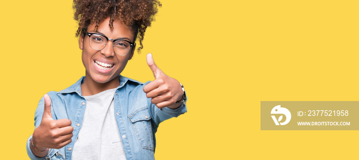 Beautiful young african american woman wearing glasses over isolated background approving doing posi