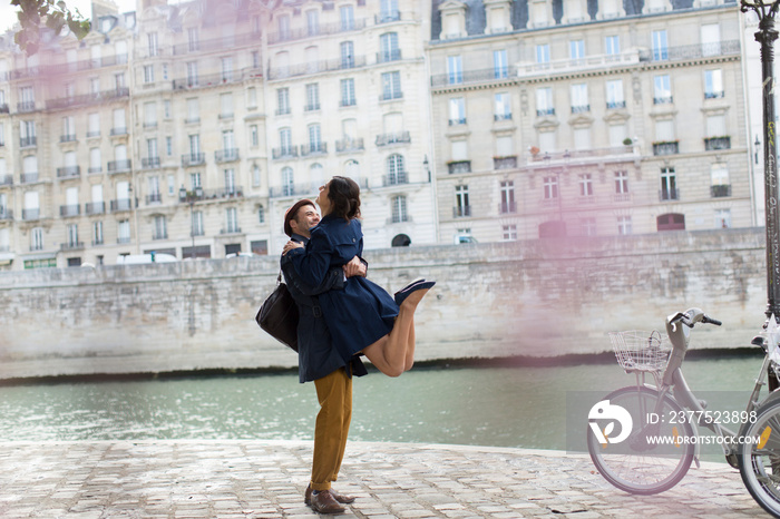 Romantic couple hugging at Seine River, Paris, France