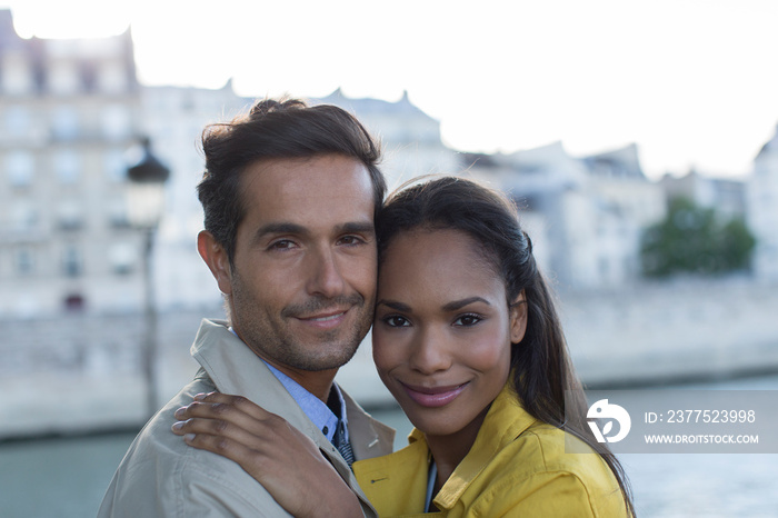 Portrait happy attractive couple hugging, Seine River, Paris, France