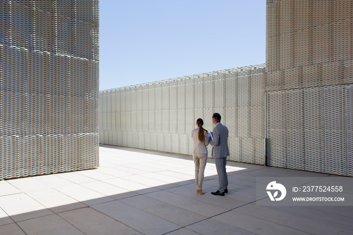 Corporate business people standing in modern courtyard