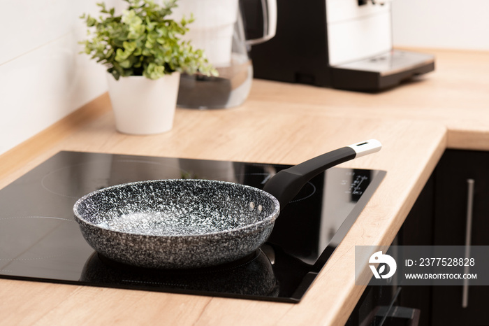 Pan in the kitchen on the induction hob