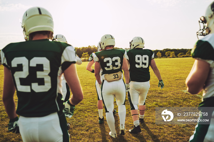 American football team walking together on a field during practi