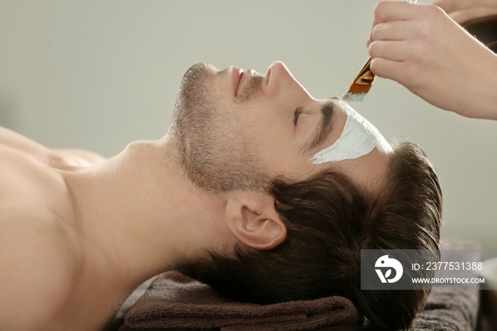 Man having cosmetic mask in spa salon