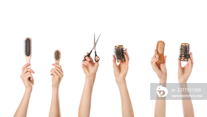 Many hands with hairdressers supplies on white background