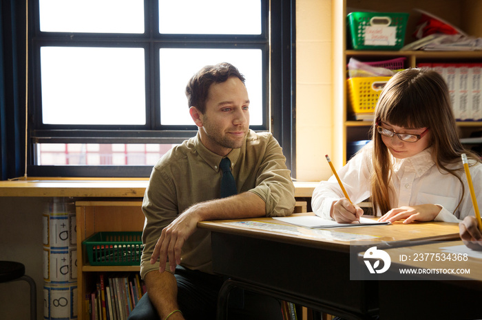 Teacher and schoolgirl in classroom