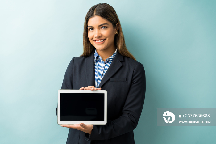 Hispanic Female Entrepreneur Showing Wireless Computer In Studio