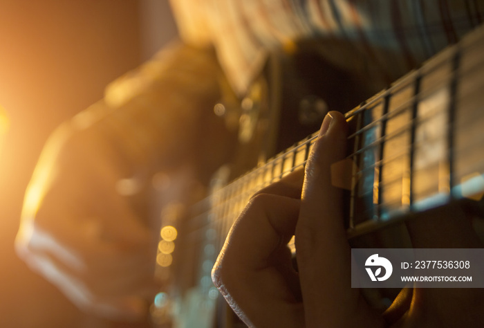 The musician is playing the guitar at a concert