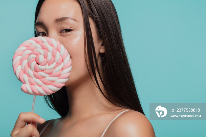 Young woman with a sugar candy