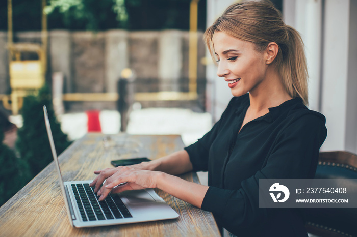 Young happy woman shopping online by using laptop connected to wifi internet network, successful smi