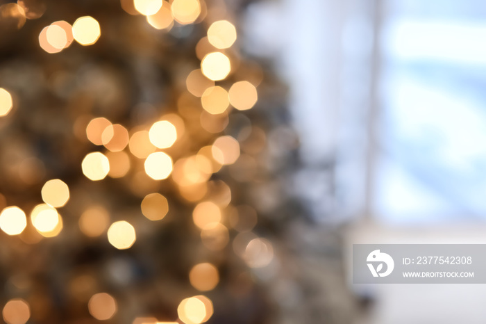 Beautiful decorated Christmas tree with glowing garland, blurred view