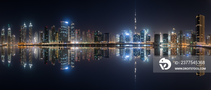 阿联酋迪拜商业湾天际线全景，夜间水中倒影