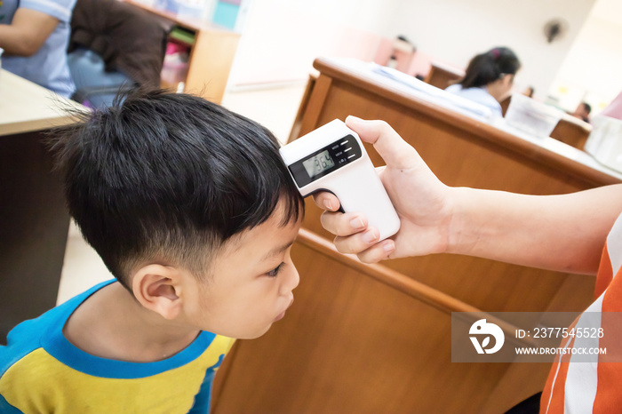 Checking measure fever levels Children using by digital infrared thermometer.