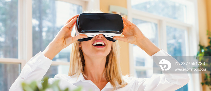 Happy young woman using a virtual reality headset