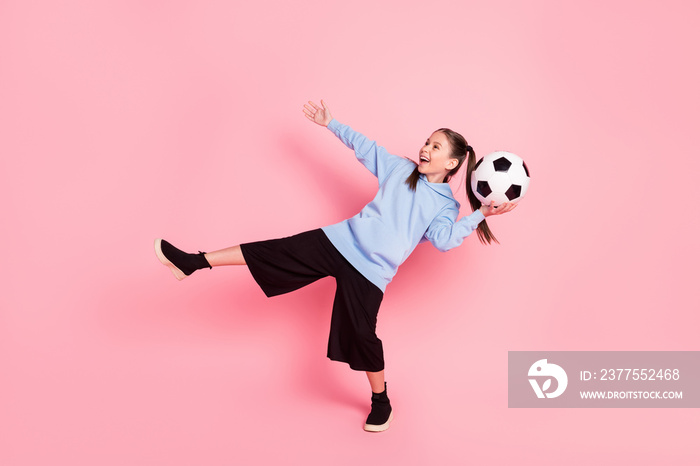 Full length body size photo of schoolgirl in sport outfit throwing ball laughing isolated pastel pin