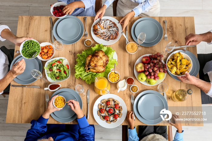 Thanksgiving Day. People eating delicious dinner at festive served table