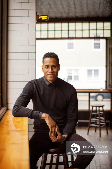 Portrait of young man sitting in bar