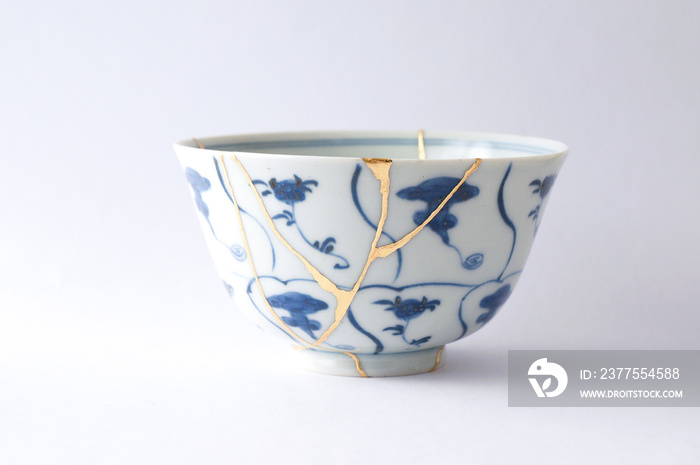 Antique Japanese ceramic kintsugi bowl restored with gold.  Antique kintsukuroi technique.