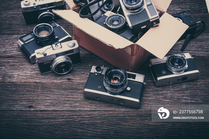 Retro film photo camera on wooden background