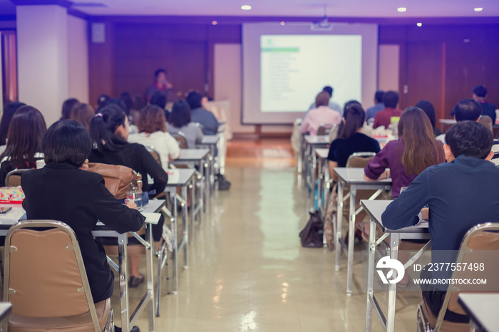 selective focus to business woman and man with blurry speaker for meeting or seminar event in the me