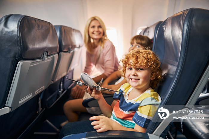 Cheerful child playing with a toy airplane