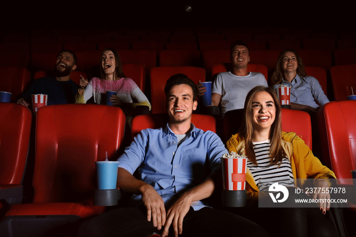 Young people watching movie in cinema