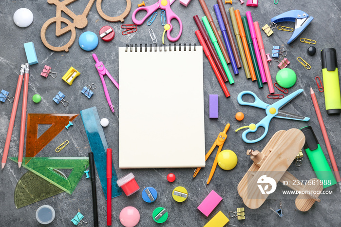 Different school stationery on grey background