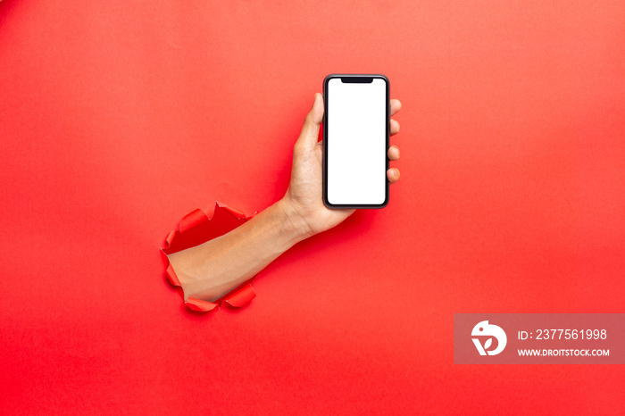 man hand holding a blank screen smart phone on Red background with clipping path