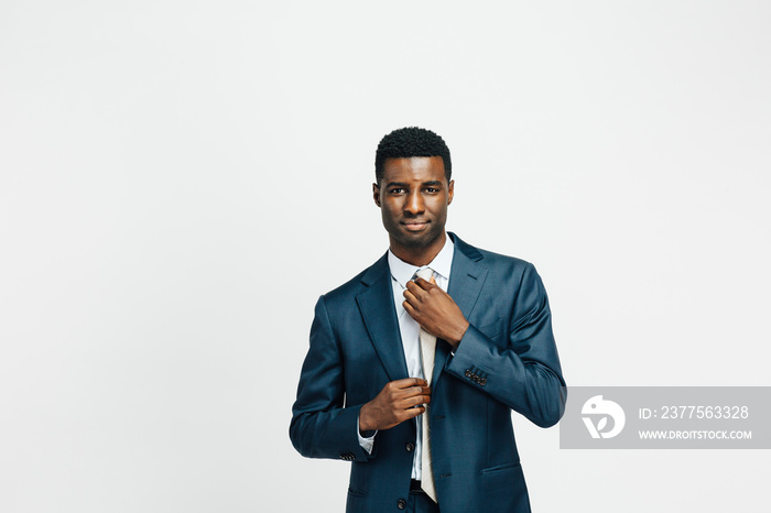 Portrait of a confident man in business suit, isolated on white studio background