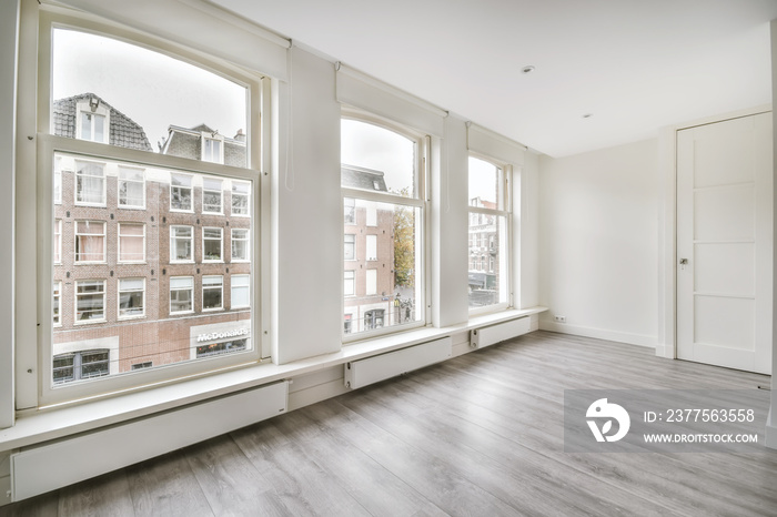 Modern room with wooden floor and white walls