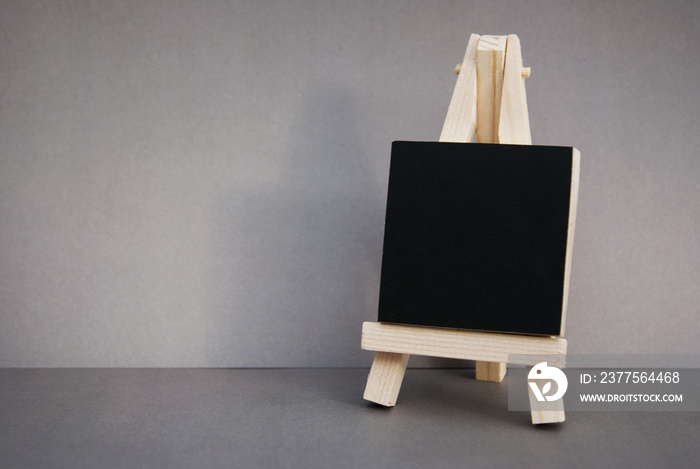 Mini blackboard chalkboard with copy space, isolated on gray background.