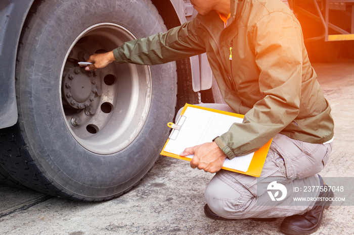 Auto Mechanic is Checking the Trucks Safety Maintenance Checklist. Inspection Safety of Semi Truck 