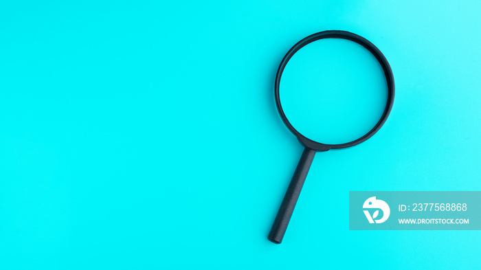 Magnifying glass isolated on blue background