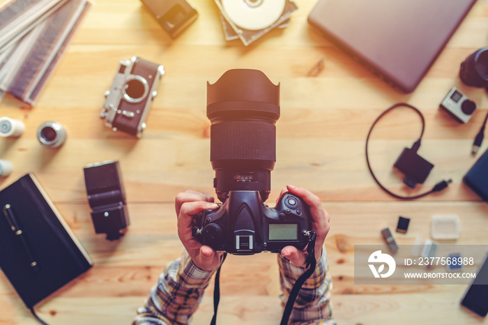 Top view of female photographer holding digital camera