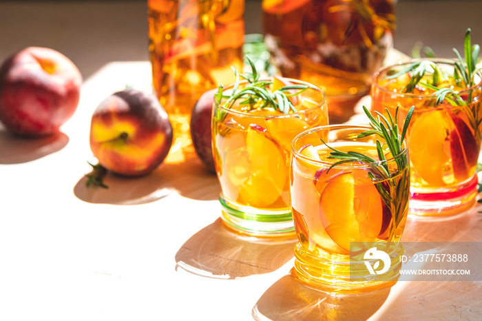 Summer cold peach fizz cocktail with rosemary