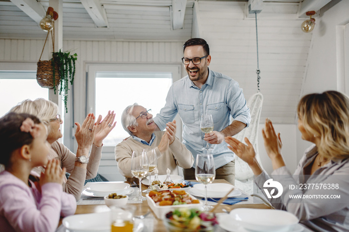 Cheerful extended family having fun during a meal in dining room.