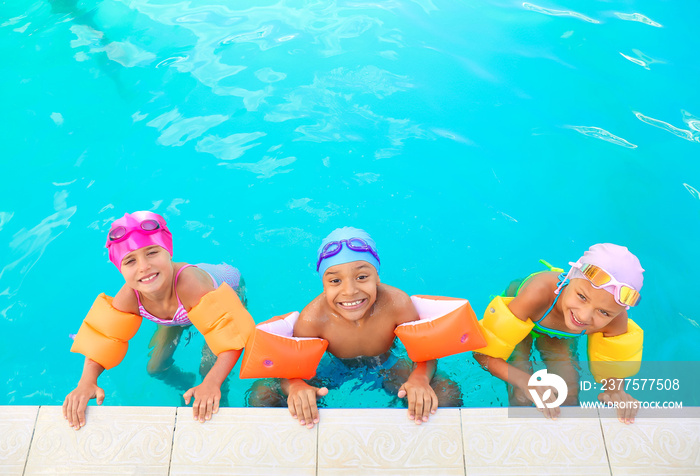 Cute little children in swimming pool