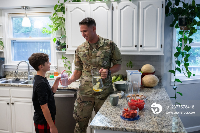 Air Force service member has breakfast with his family before leaving for work.