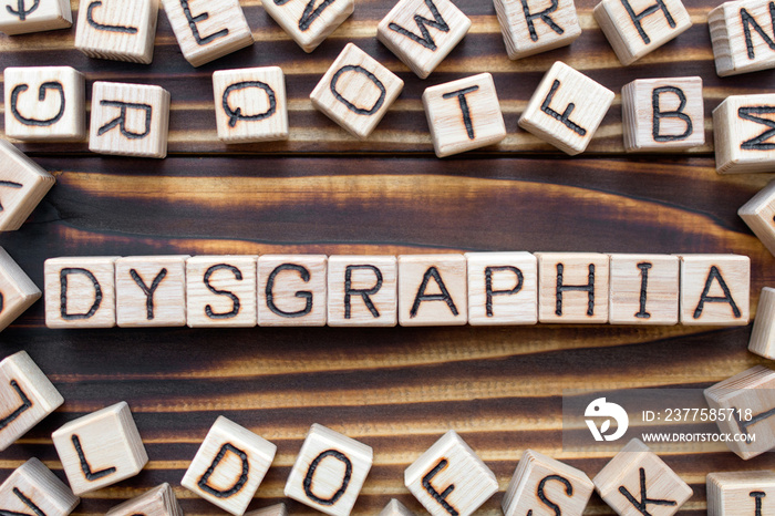 dysgraphia wooden cubes with letters, learning disability writing disorder concept, around the cubes