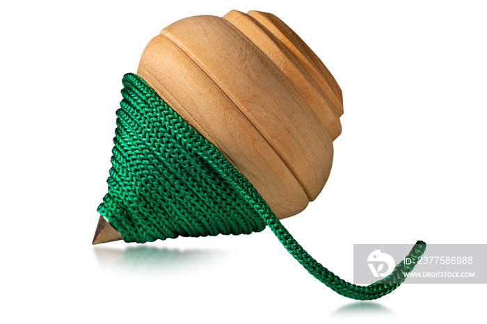 Close-up of a wooden spinning top with a green rope, isolated on white background. Vintage toy