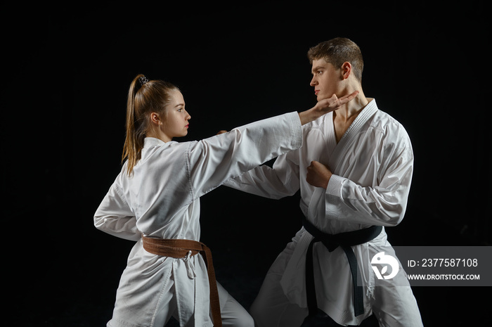 Female karate fighter on training with master